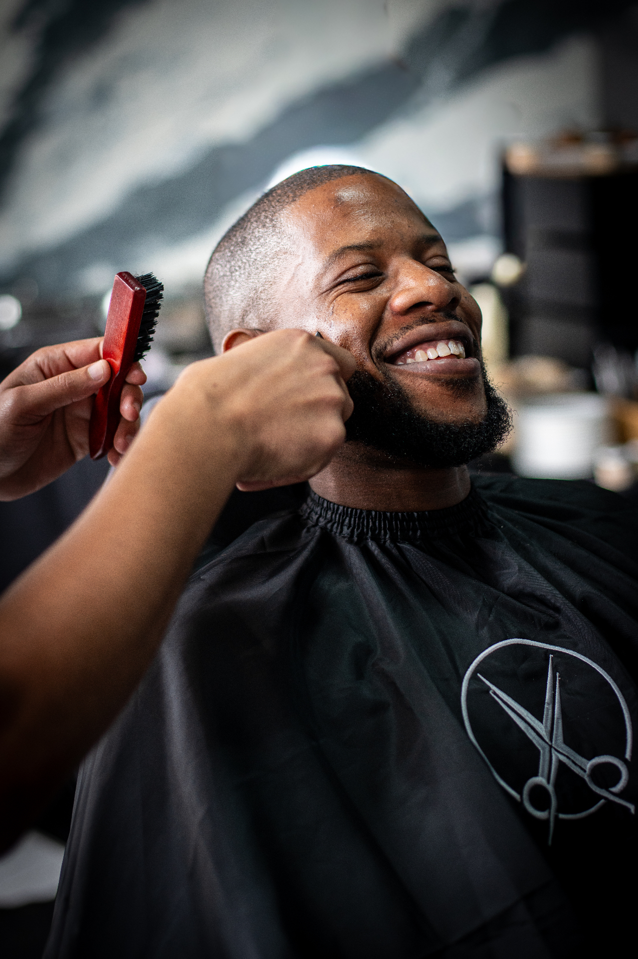 Client smiling after a fresh beard line-up